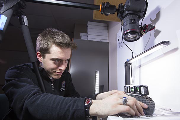 A student uses a mounted camera to shoot shoe forensics in a lab