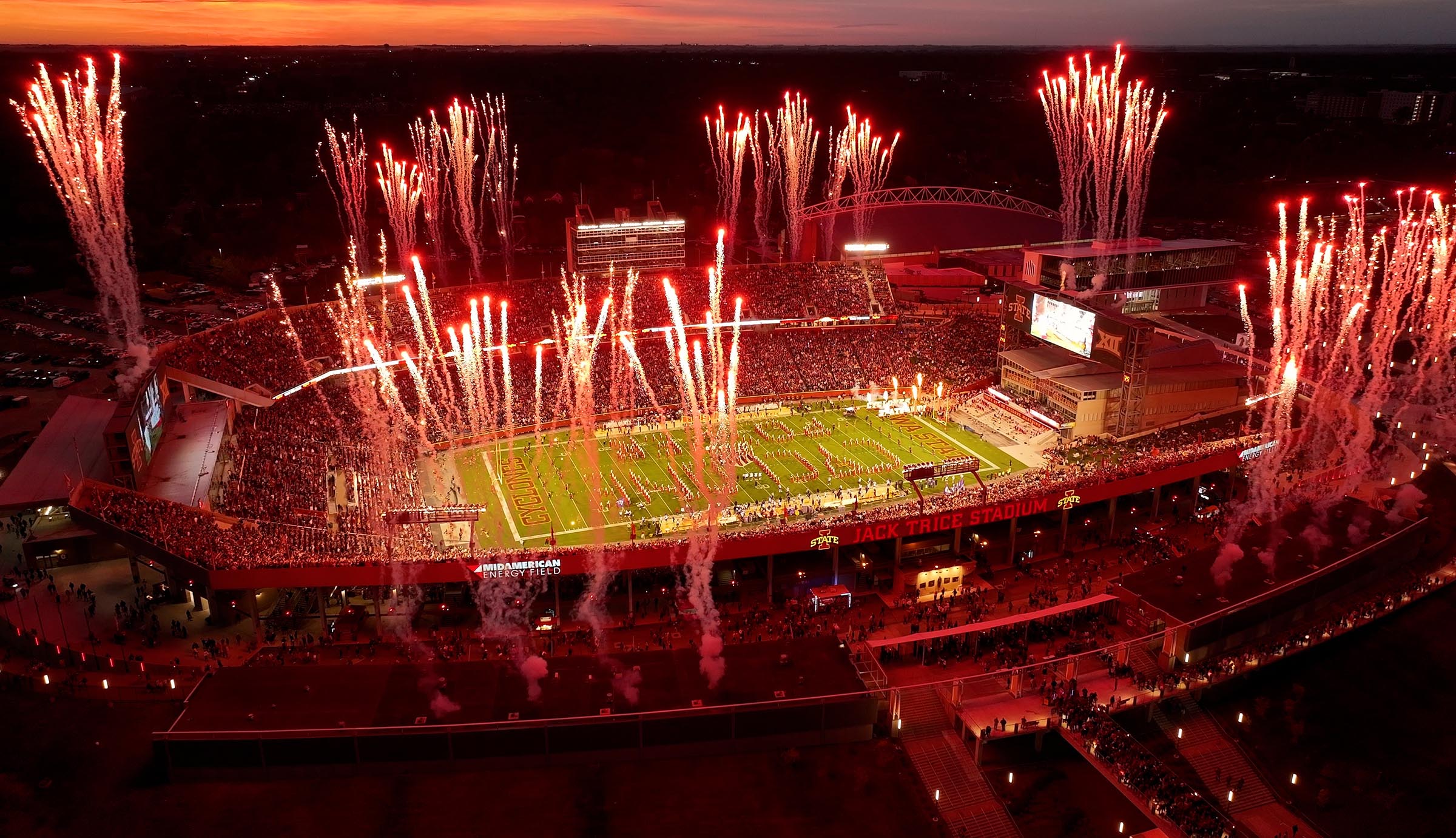 Overhead view of an Iowa State football night game with fireworks shooting over the stadium.
