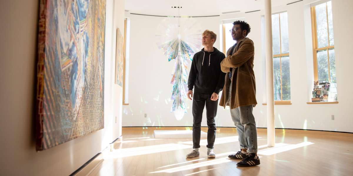 Two students looking at an art exhibit