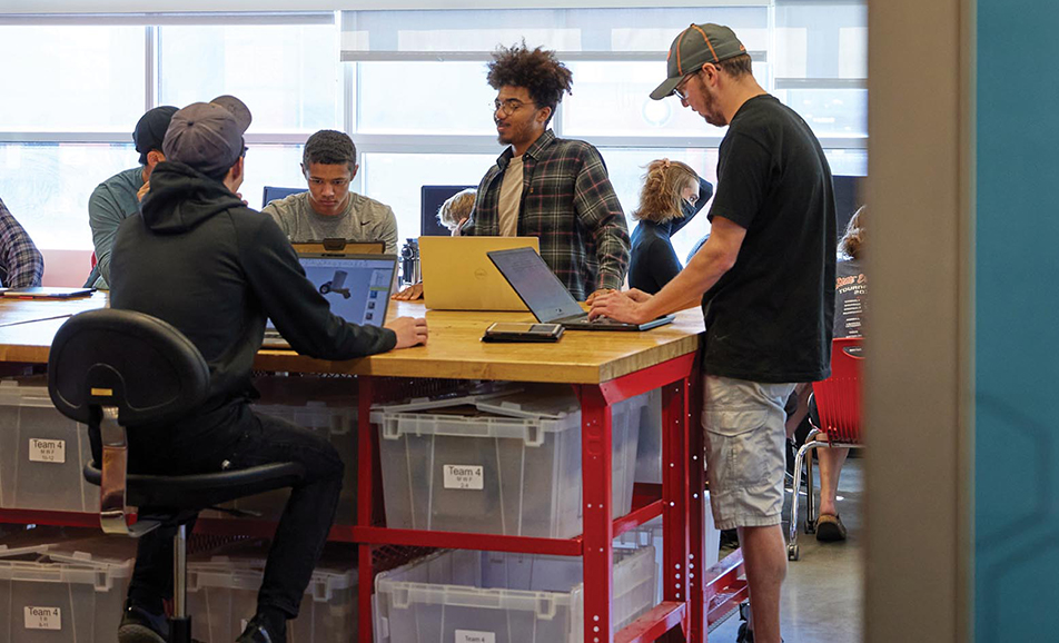 A group of students work on laptops in an Engineering space