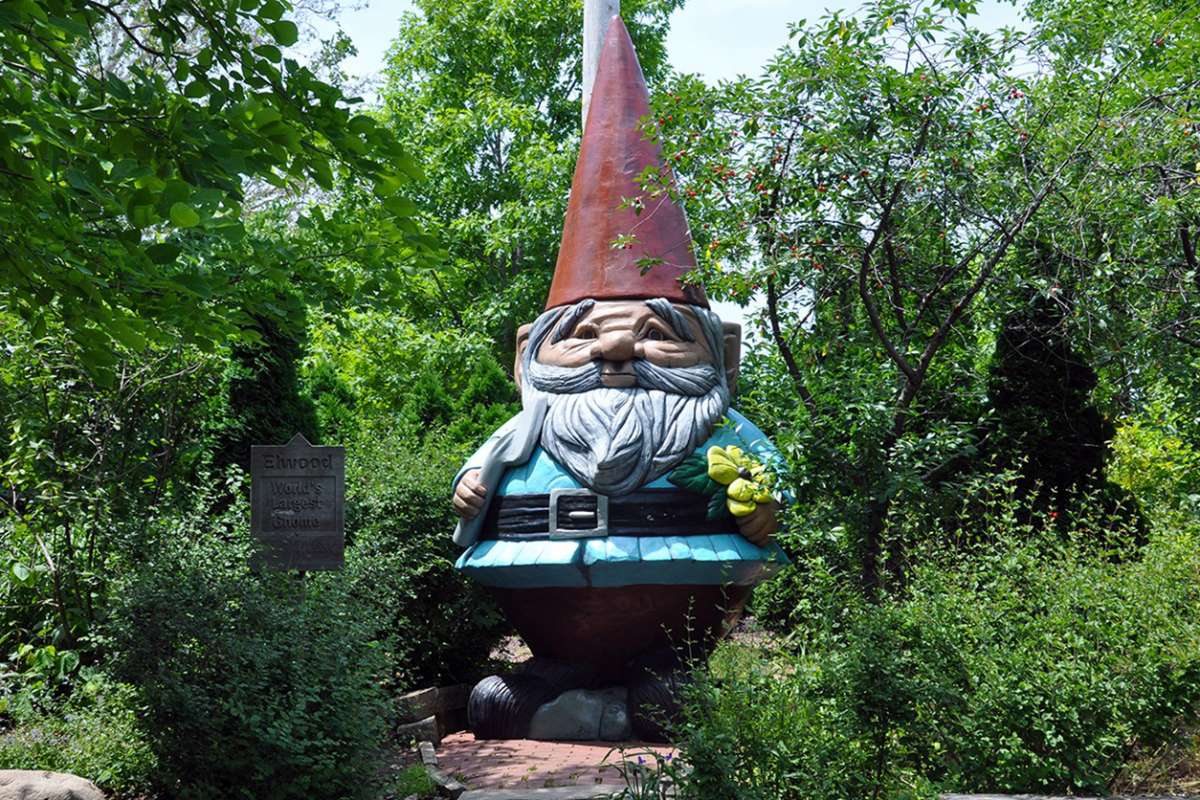 Reiman Gardens' 15-foot concrete gnome nestled in a lush green setting