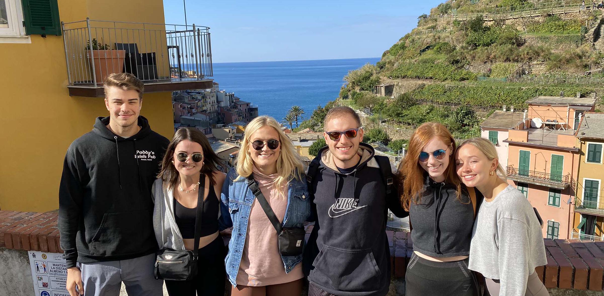 Group of study abroad students with a seaside background
