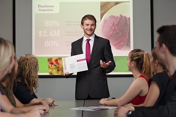 A student pitches an entrepreneurial idea to a group