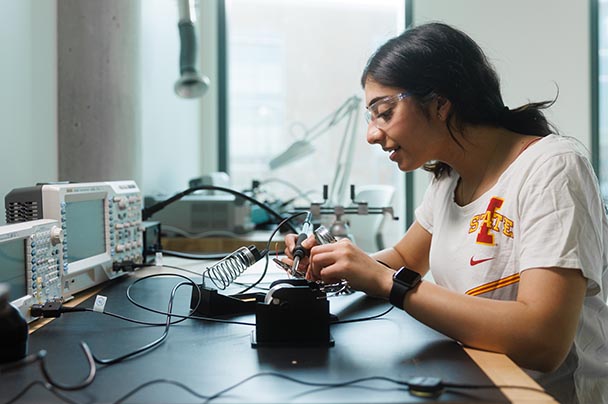 A student works on electrical components