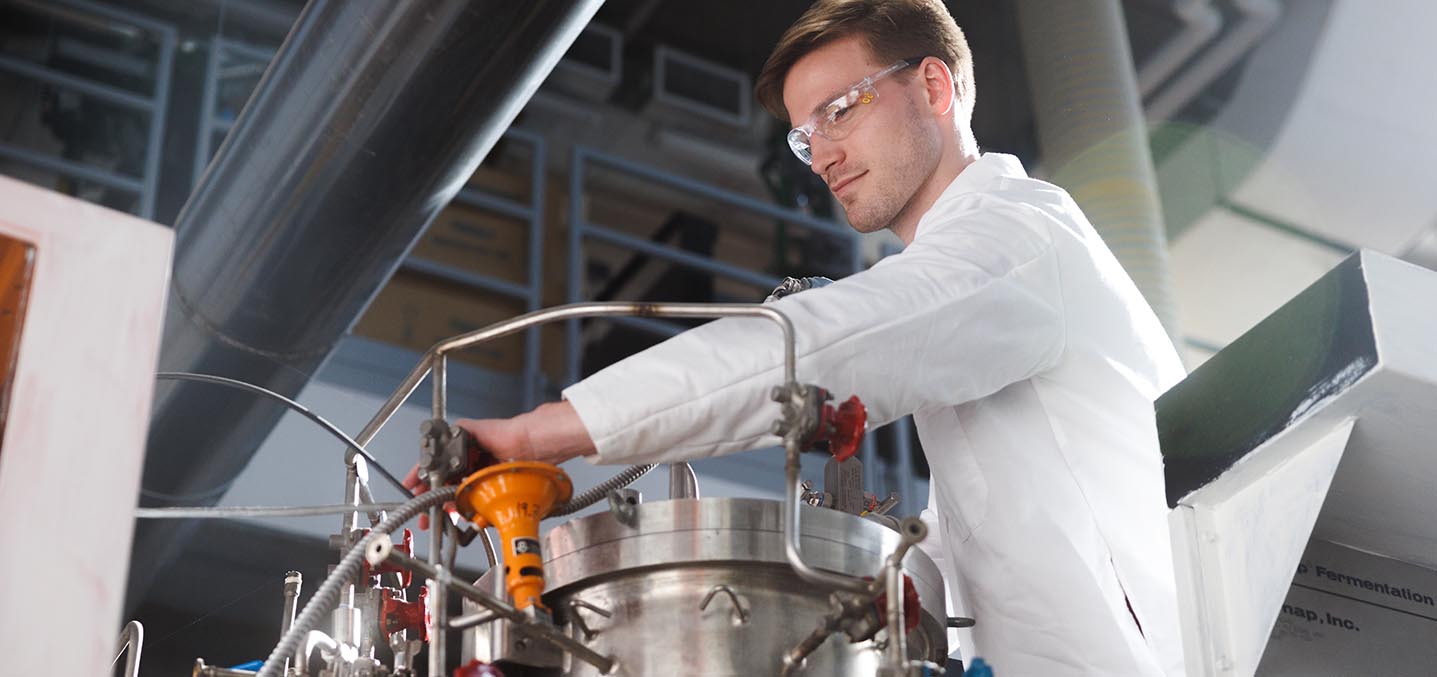 A student works on equipment in an engineering lab