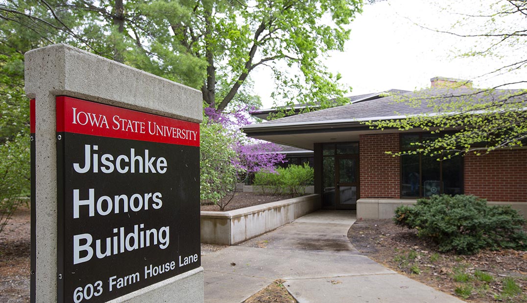 Exterior springtime view of the Jischke Honors Building and its sign