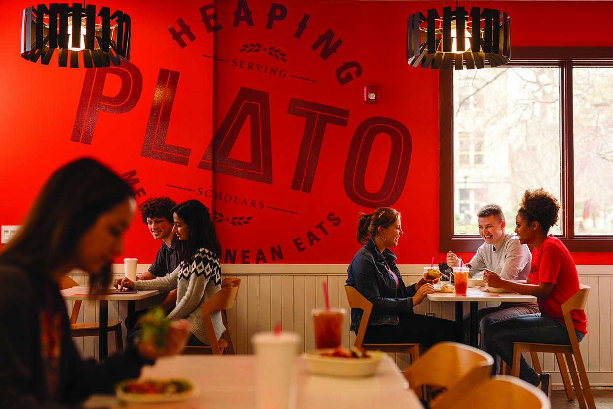 Students eat at tables in the Heaping Plato dining area
