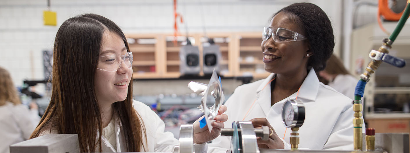 Two students work in an engineering lab