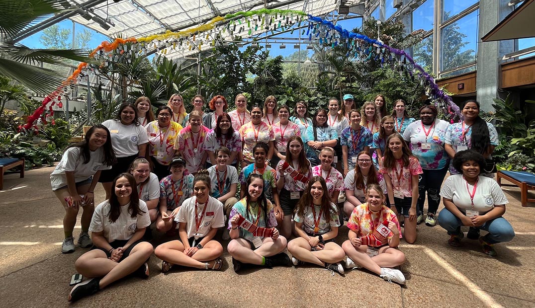A large group shot of WiSE student participants in the Reiman Gardens conservatory