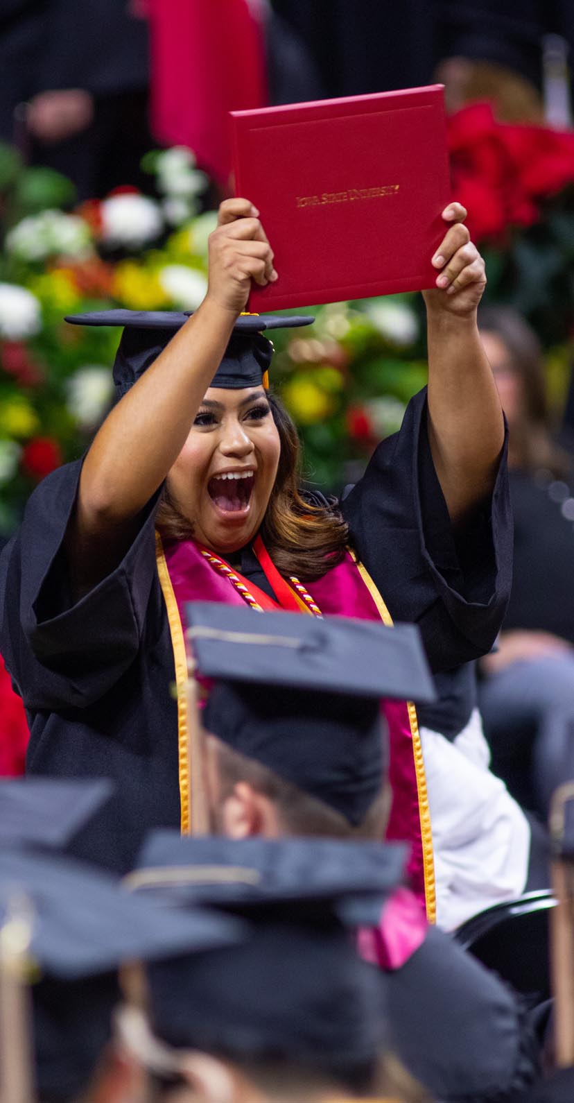 A graduate celebrates after receiving her diploma during the commencement ceremony.