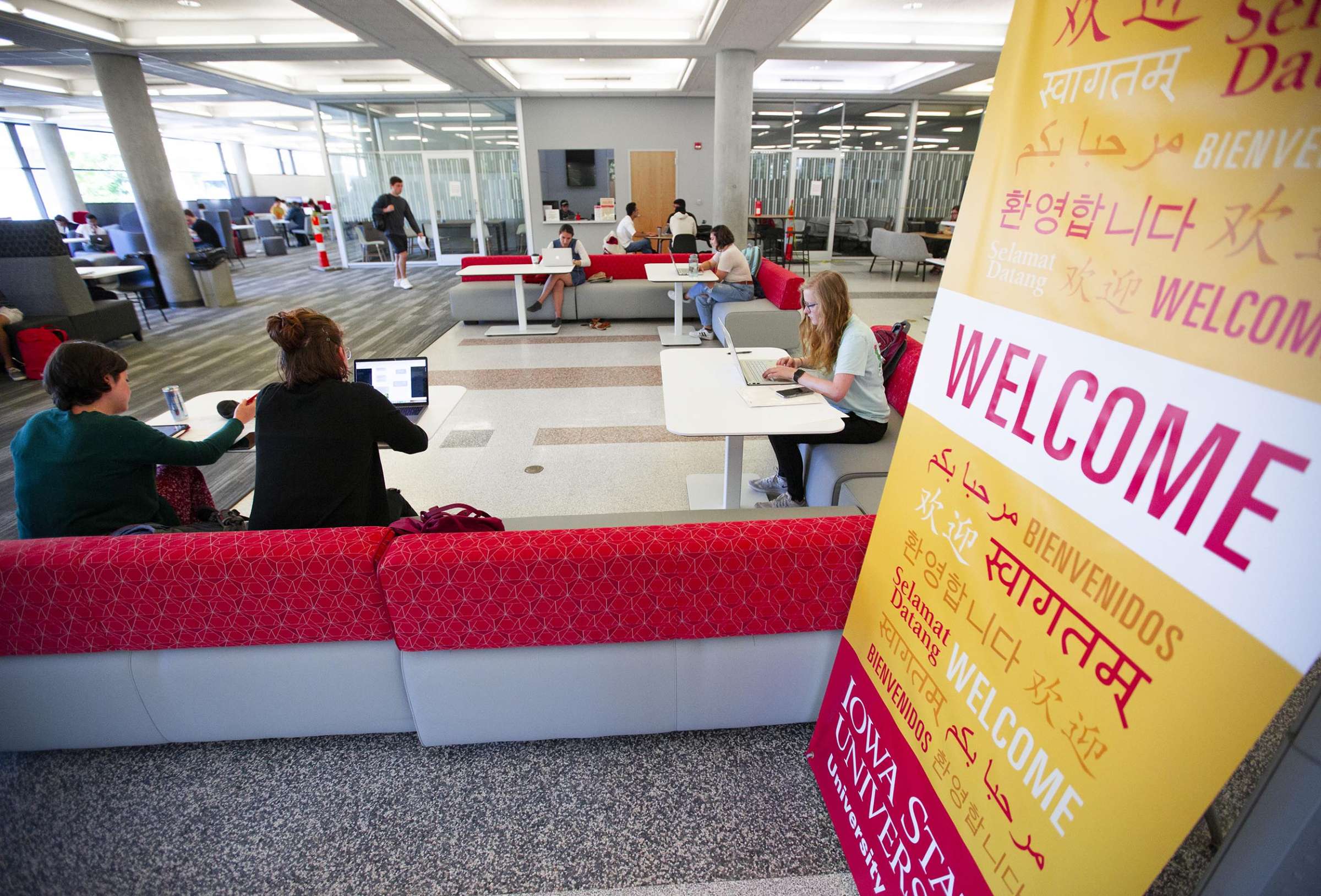 Welcome sign in many languages, located in the Parks Library lobby space