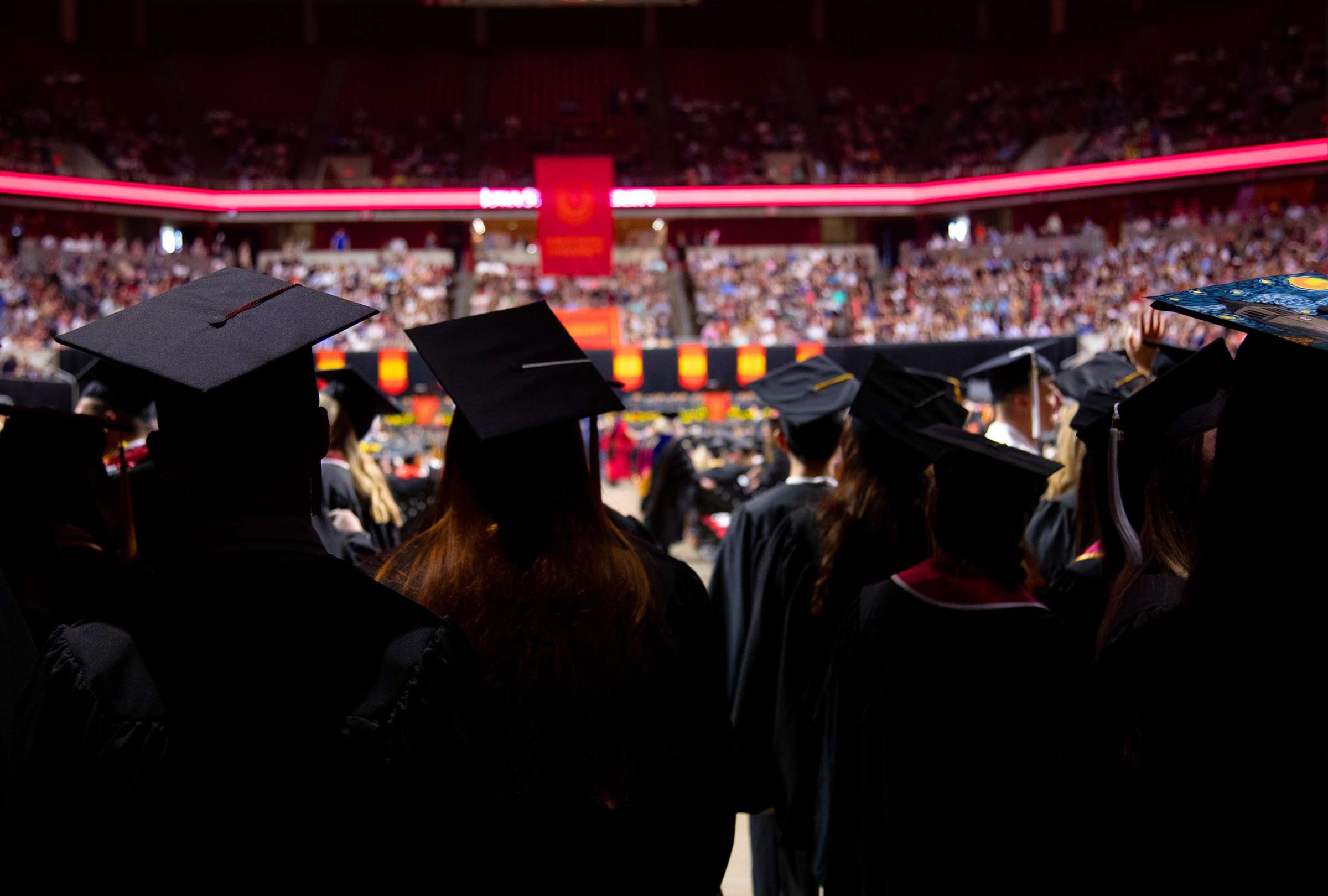 View from behind a group of graduates ready to process into the ceremony