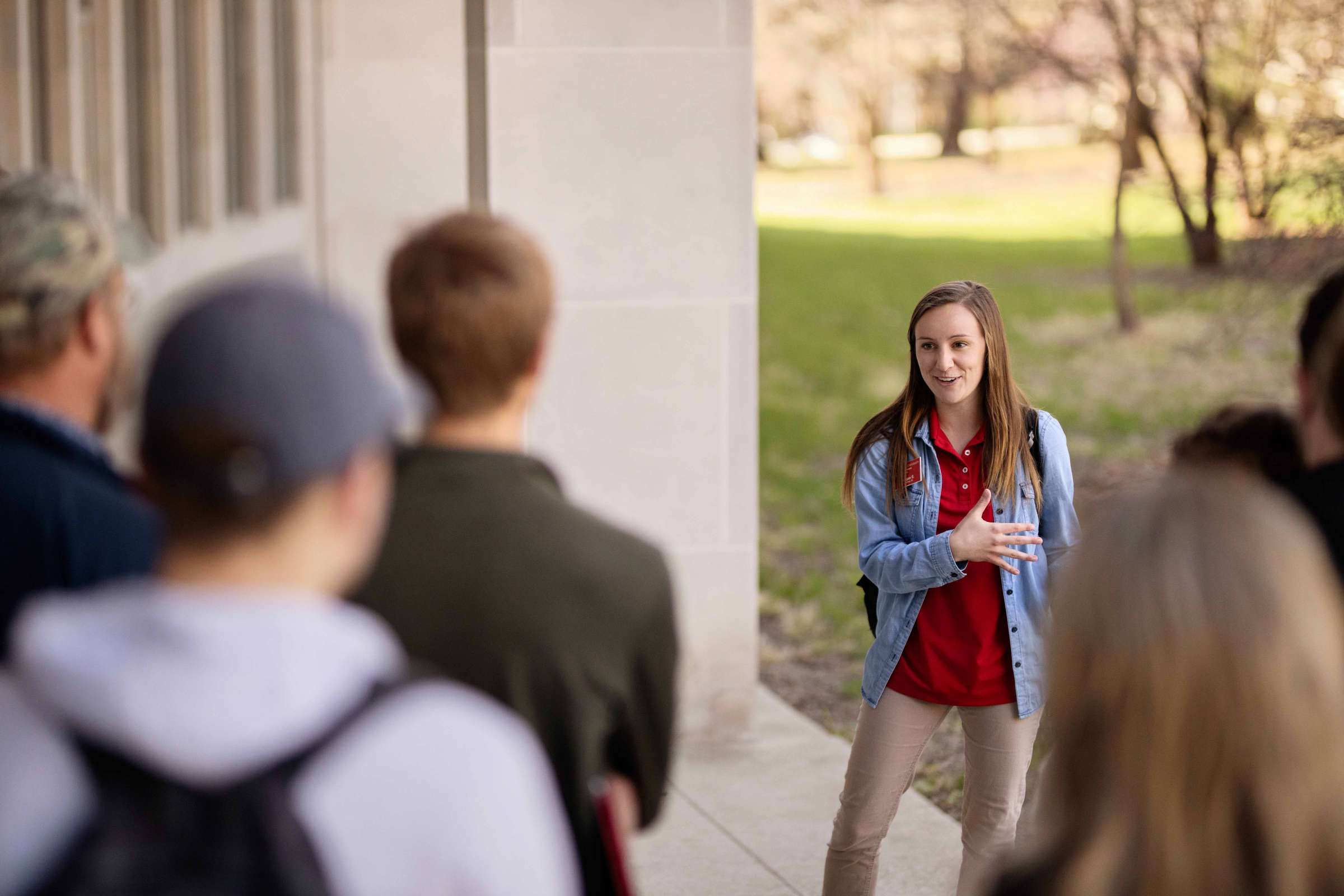 A student leads a tour of campus