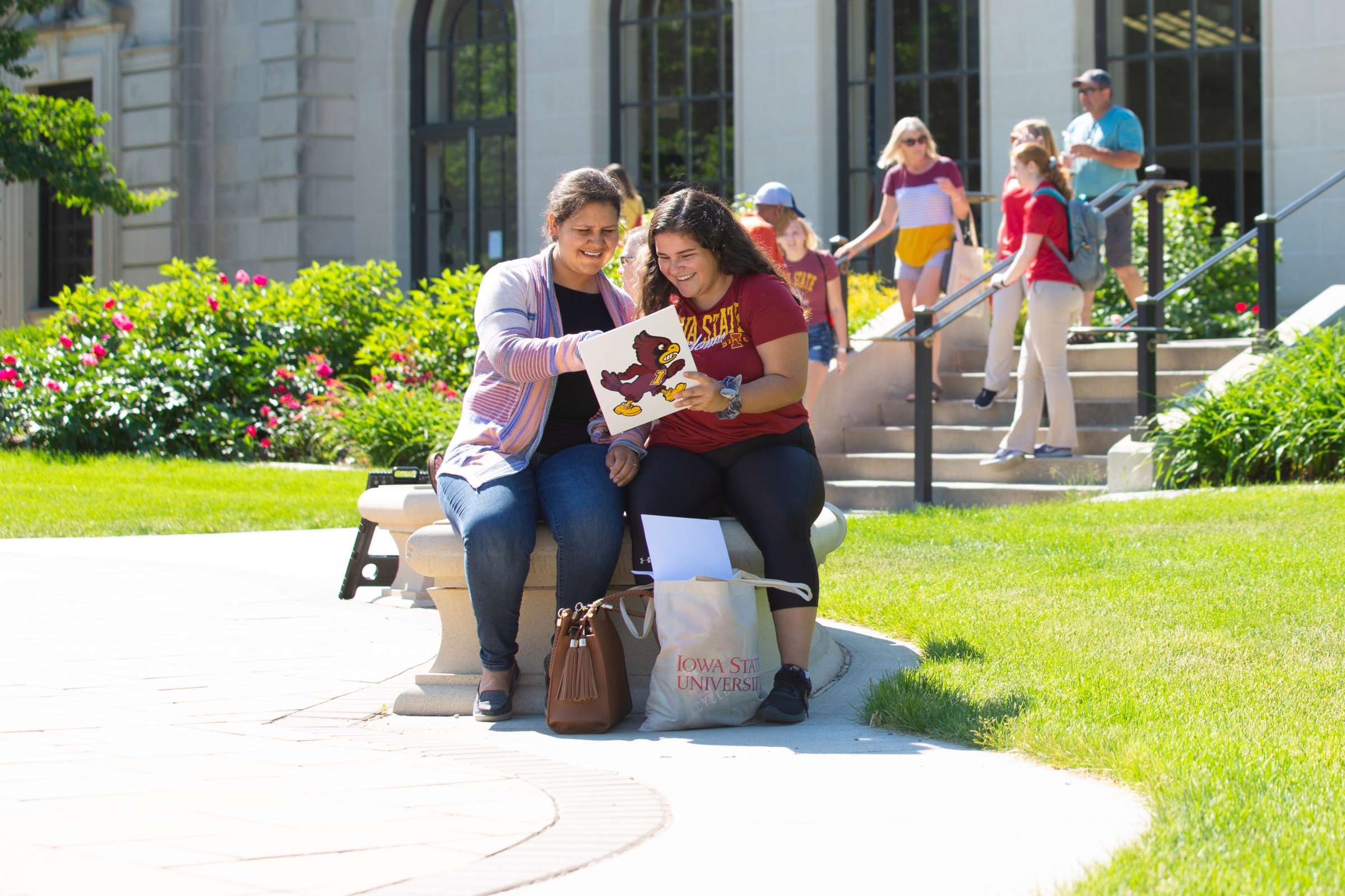 A family views orientation materials in front of the Memorial Union.