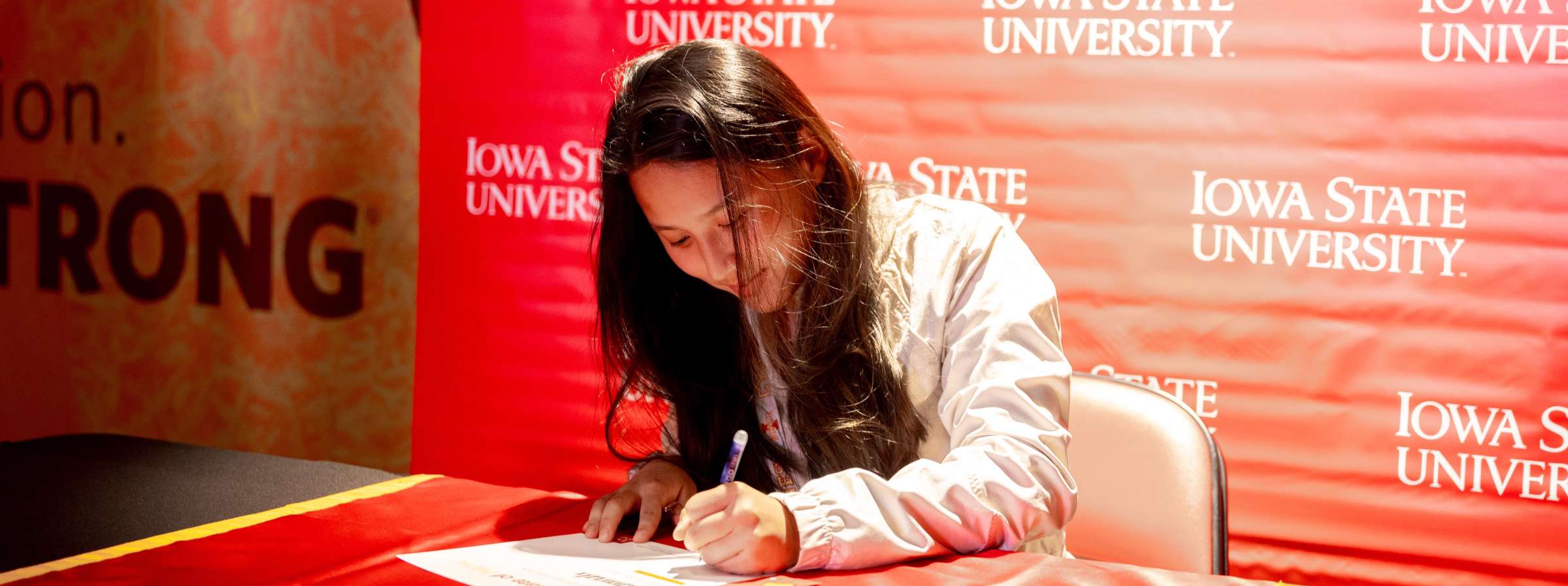 Student signs certificate of acceptance