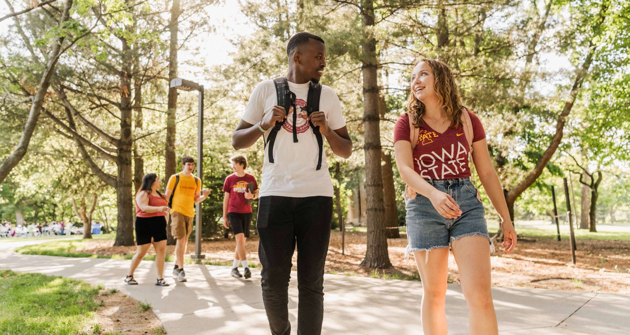 five students walking on campus