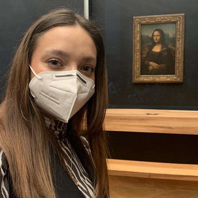 Sarah Pilut with the Mona Lisa during her study abroad experience